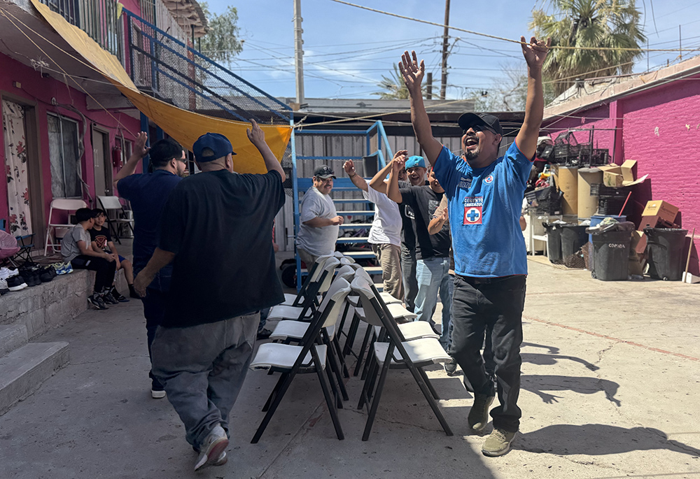 Men at the Cobina Posada del Migrante shelter play musical chairs during a Father’s Day celebration organized by women religious and their friends June 6, 2026 in Mexicali, Mexico. (GSR photo/Rhina Guidos)