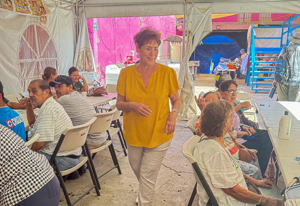 St. Joseph of Carondelet Sr. Suzanne Jabro, in yellow, smiles at a group of women at the Cobina Posada del Migrante shelter during a Father’s Day celebration June 6, 2026. Jabro, who spent decades in prison ministry, is the founder of Border Compassion, which facilitates encounters between migrants, sisters, ecumenical groups and others. (Courtesy of Sr. Teresa Lynch)