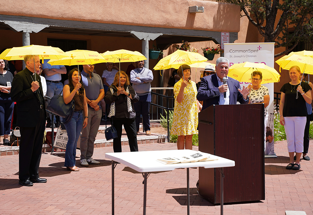 Allen Sánchez, president of the nonprofit CommonSpirit St. Joseph's Children, speaks about the sainthood cause of Sr. Blandina Segale of the Sisters of Charity, June 1 in Santa Fe, New Mexico, in front of a convent named for Segale. Pictured, far left, is Archbishop John Wester of Santa Fe, New Mexico. (Courtesy of the Sisters of Charity of Cincinnati)