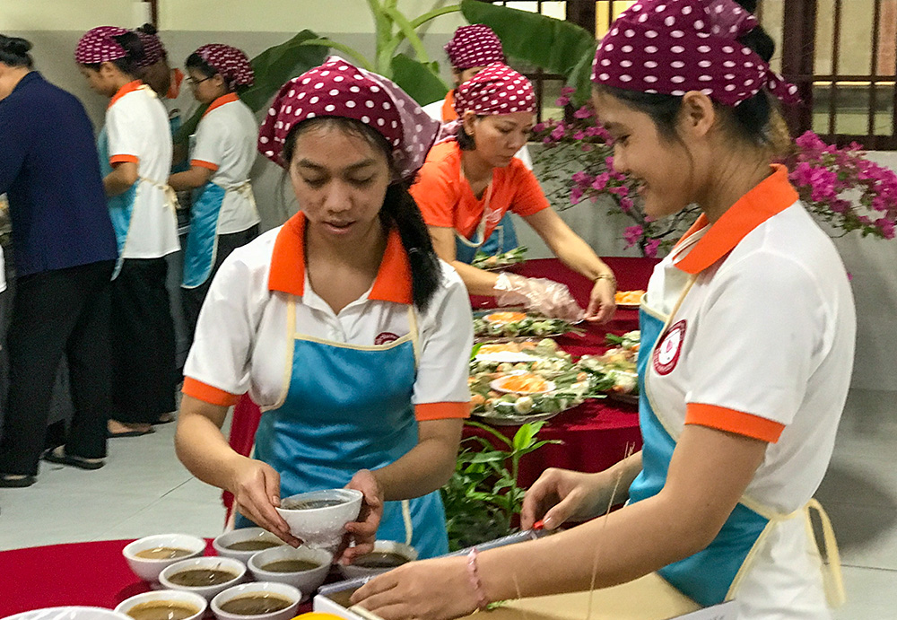 Housemaids prepare food during the 20th anniversary celebration of the Daughters of Charity of St. Vincent de Paul sisters' housemaid training program on May 10, 2026, in Ho Chi Minh City, Vietnam. (Joachim Pham)