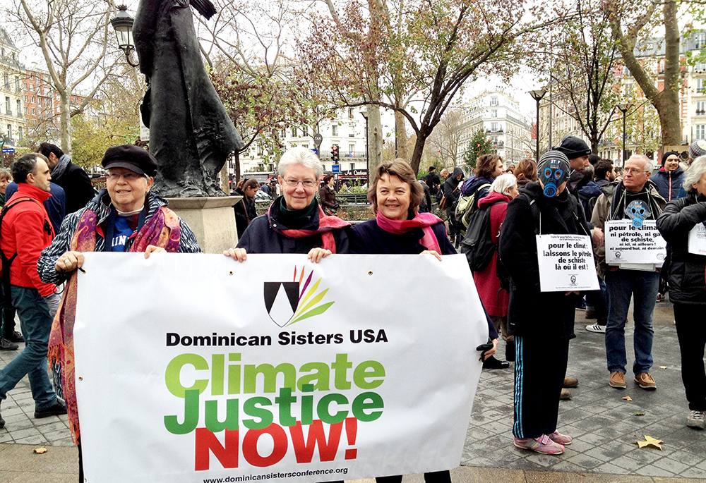 In this 2015 file photo, Adrian Dominican Sr. Patricia Siemen, Amityville Dominican Sr. Margaret Mayce and Adrian Dominican Sr. Elise García demonstrate in Paris for climate justice. (CNS/Global Sisters Report)