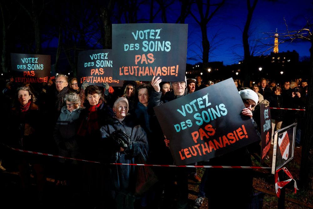 People hold placards reading, "Vote for care. Not euthanasia," during a demonstration in Paris Feb. 16, 2026, as France debates a bill to legalize "assisted dying." (OSV News/Reuters/Benoit Tessier)