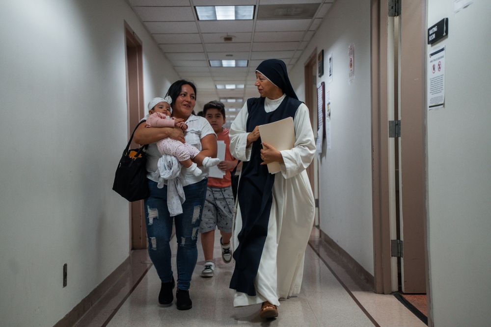 A Catholic nun accompanies a family of asylum seekers inside immigration court on Aug. 1, 2025, in New York. (AP/Olga Fedorova)
