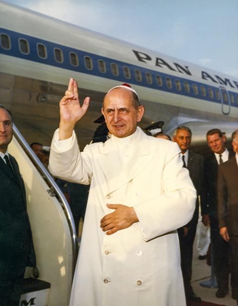 Pope Paul VI offers a blessing at Rome's Leonardo da Vinci Airport before boarding a flight to Istanbul in 1967. (CNS file)