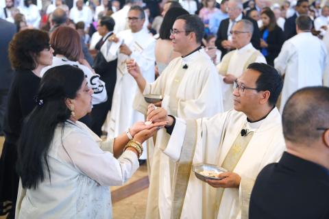Auxiliary Bishops Felipe Pulido and Michael M. Pham distribute Communion during their episcopal ordination Mass at St. Therese of Carmel Church in San Diego Sep. 28, 2023