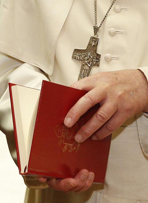 Pope Francis holds a copy of his exhortation Evangelii Gaudium ("The Joy of the Gospel") in this file photo from 2014. The document, published Nov. 24, 2013, commonly is described as presenting the vision for Pope Francis' pontificate. (CNS/Paul Haring)