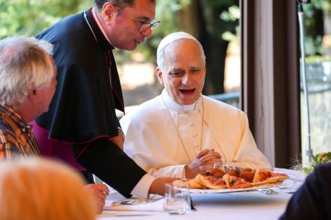 Pope Leo XIV reacts as a tray of food is served during lunch with guests assisted by the Albano diocesan Caritas agency at the Borgo Laudato Si’ in Castel Gandolfo, Italy, Aug. 17, 2025. (CNS photo/Lola Gomez)