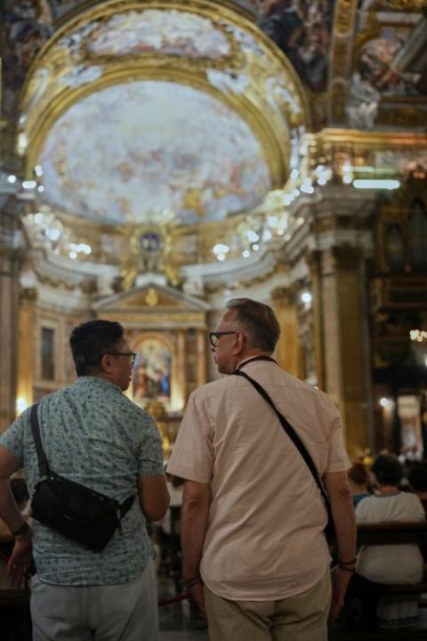 Justin Del Rosario and John Capozzi attend a vigil prayer for members of the LGBTQ+ community