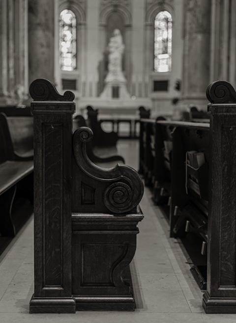 A black and white photo of pews in a church (Unsplash/Heidi Erickson)