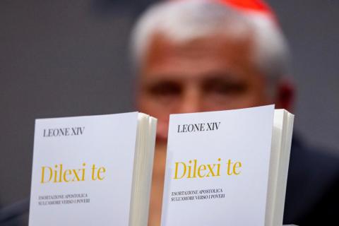 Copies of the Italian translation of "Dilexi Te" ("I Have Loved You"), Pope Leo XIV's apostolic exhortation, are seen in front of Cardinal Konrad Krajewski, prefect of the Dicastery for the Service of Charity, at a Vatican news conference Oct. 9, 2025. (CNS/Pablo Esparza)