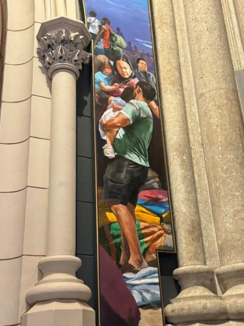 Migrants are featured in a mural.
