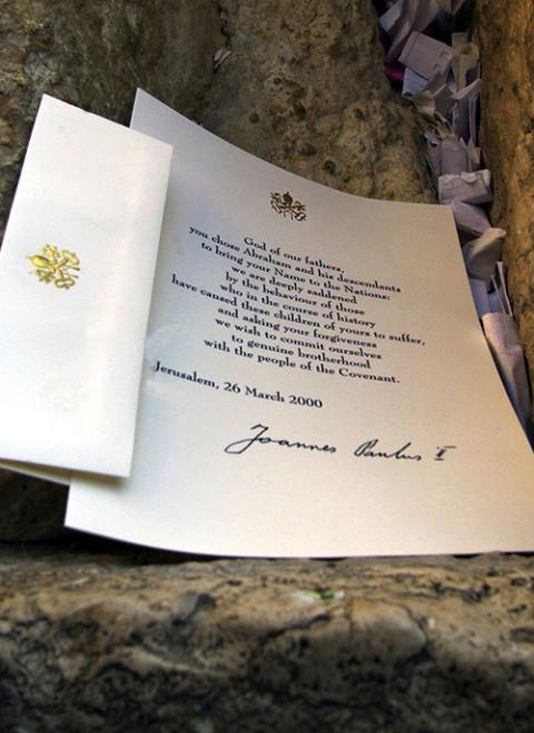 A prayer that begins ''God of our fathers ...'' was left in a crevice of Jerusalem's Western Wall by Pope John Paul II March 26, 2000. He was the first pontiff to pray at Judaism's most sacred site. (CNS photo/Reuters)