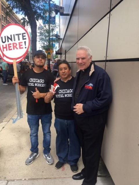 Fr. Clete Kiley, right, accompanies striking hotel workers in Chicago.