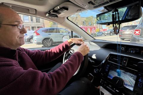 A rosary and a blue whistle hang around the rearview mirror of Dominican Fr. Brendan Curran’s car.