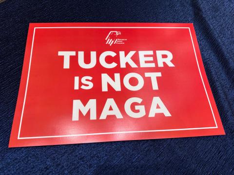 A red sign stating "Tucker is not MAGA," waved by college students attending the Republican Jewish Coalition conference in protest of the conservative talk show host's interview of right-wing podcaster Nick Fuentes, who has espoused antisemitic beliefs, is pictured at the Venetian Resort, Saturday, Nov. 1, 2025, in Las Vegas. (AP/Thomas Beaumont)