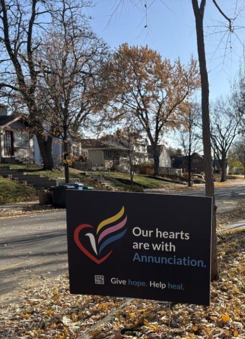 Lawn  sign reads "Our hearts are with Annunciation."