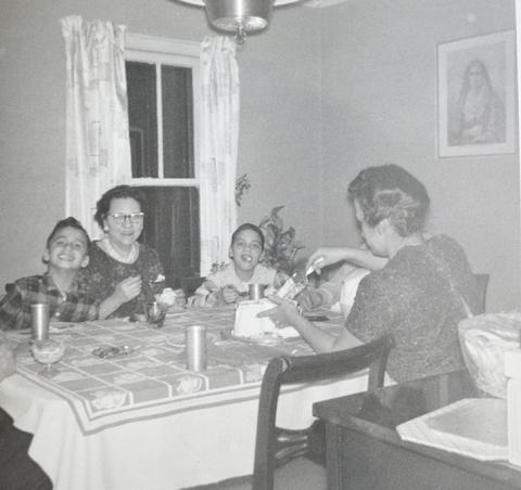 In this undated photo, Pope Leo XIV (then Robert Prevost, left) smiles while his mother (back to the camera) cuts a birthday cake in what his brother (right) guessed was the pope's ninth birthday, at the family home in Dolton, Illinois. (OSV News/Prevost family)