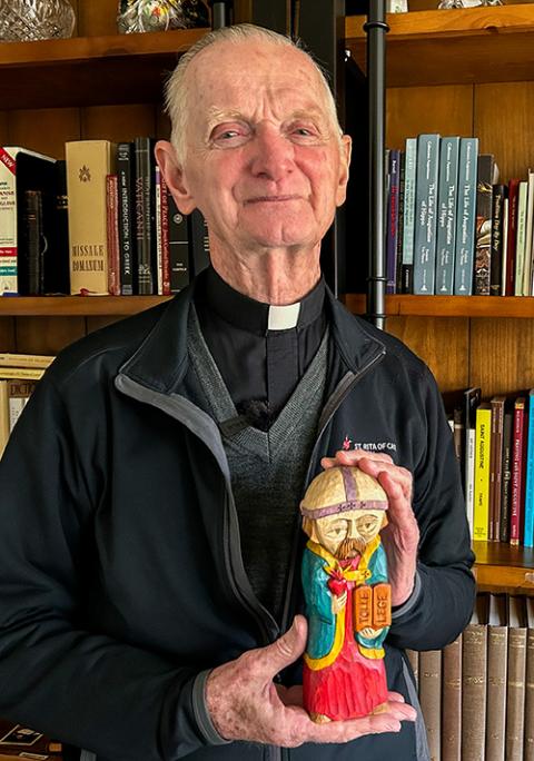 Emeritus Bishop Dan Turley of Chulucanas, Peru, holds a statue of St. Augustine while standing for a photo at St. Rita of Cascia Parish in Chicago Oct. 24, 2025. (NCR photo/Justin McLellan)