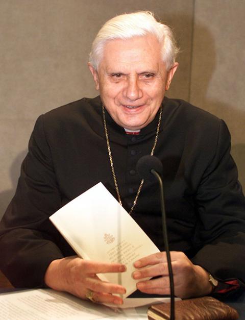 Cardinal Joseph Ratzinger presents a copy of Pope John Paul II's latest encyclical, Fides et Ratio (''Faith and Reason''), at the Vatican Oct. 15, 1998. (CNS/Reuters)
