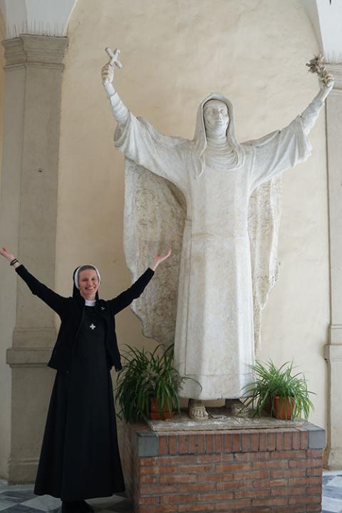Basilian Sr. Emanujila Vishka poses for a photo with a statue of St. Catherine of Siena near the Basilica of San Domenico in Siena, Italy. (Courtesy of Emanujilla Vishka)