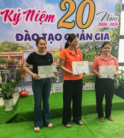 Mary Vu Hoai Thuong, in black, and others receive certificates of merit from the nuns for completing university studies while working as housemaids on May 10, 2026. (Joachim Pham)