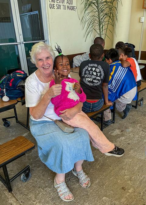 Sr. Rose Kuhn, of the Sisters, Servants of the Immaculate Heart of Mary in Immaculata, Pennsylvania, with a child at an immigrant center in Mexico, just south of the border at McAllen, Texas, where she ministers. (Courtesy of Rose Kuhn)