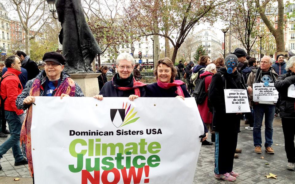In this 2015 file photo, Adrian Dominican Sr. Patricia Siemen, Amityville Dominican Sr. Margaret Mayce and Adrian Dominican Sr. Elise García demonstrate in Paris for climate justice. (CNS/Global Sisters Report)