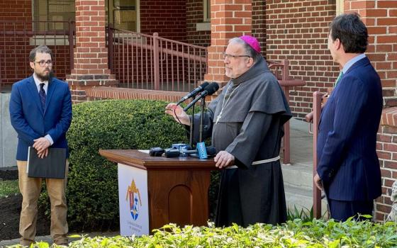 Bishop John Stowe of Lexington, Kentucky, center, speaks at press conference. With him are Bishop John Stowe of Lexington, Kentucky, announces a net-zero initiative.  With him are Adam Edelen (right), founder and CEO of Edelen Renewables, and Joshua Van Cleef (left).