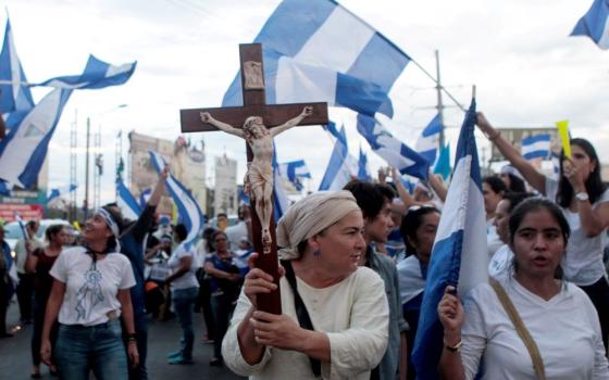 A demonstrator holds a crucifix during a protest against Nicaraguan President Daniel Ortega's government in Managua May 15, 2018. Since that year, the U.S. State Department says, at least 3,600 nonprofits in Nicaragua, including religious congregations, have had their legal status stripped in the country. (OSV News/Reuters/Oswaldo Rivas)