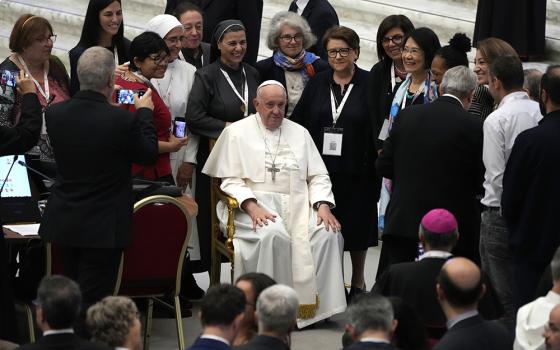 Pope Francis poses with a group of women before a session of the 16th general assembly of the synod of bishops in the Paul VI Hall at The Vatican, Oct. 28, 2023. The seventh from left is Sr. Nathalie Becquart, undersecretary in the Vatican's Synod of Bishops. (AP/Alessandra Tarantino)
