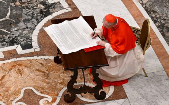 Parolin signs scroll.