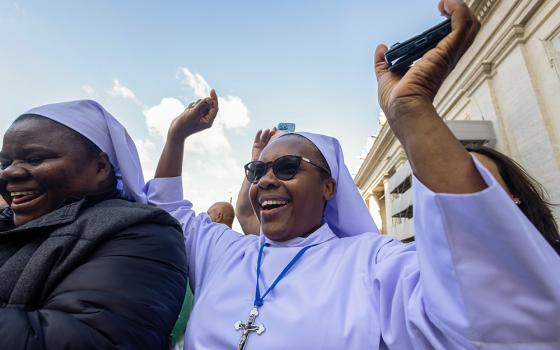 Crowds cheer in St. Peter's Square as white smoke emerges from the chimney atop the Sistine Chapel at the Vatican May 8, 2025, indicating Pope Leo XIV, the former Cardinal Robert Prevost, was elected pope. (CNS/Pablo Esparza)