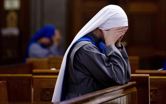 A novice prays prior to the start of her profession of vows in this 2017 file photo. (CNS/Tyler Orsburn)