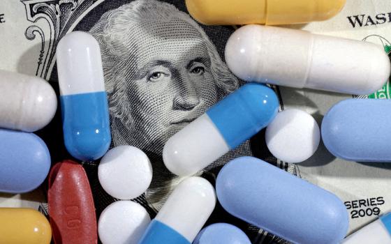 A U.S. dollar bill and medicines are seen in this illustration, taken June 27, 2024. (OSV News/Reuters/Dado Ruvic)