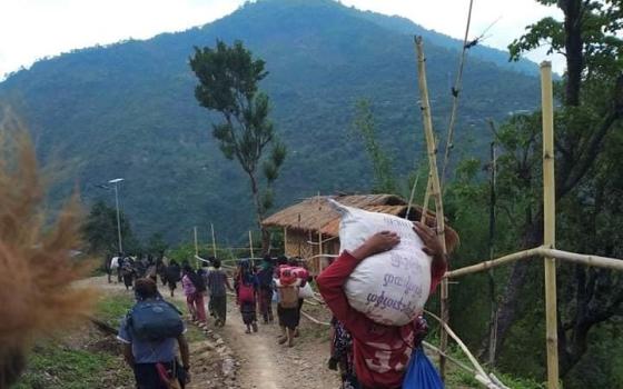 People in northwestern Myanmar displaced by fighting between junta forces and anti-junta fighters walk in Chin state May 31, 2021. A third church in Kayah state, a Catholic stronghold in eastern Myanmar, was damaged by indiscriminate shelling by the military June 6. (CNS/Reuters)
