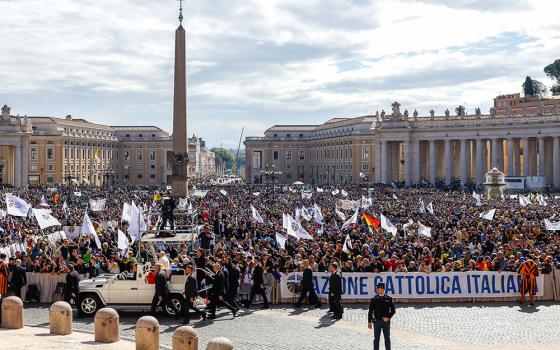 Pope Francis greets people as he rides the popemobile around St. Peter's Square before a meeting with members of Italy's Catholic Action lay association at the Vatican April 25, 2024. (CNS/Lola Gomez)
