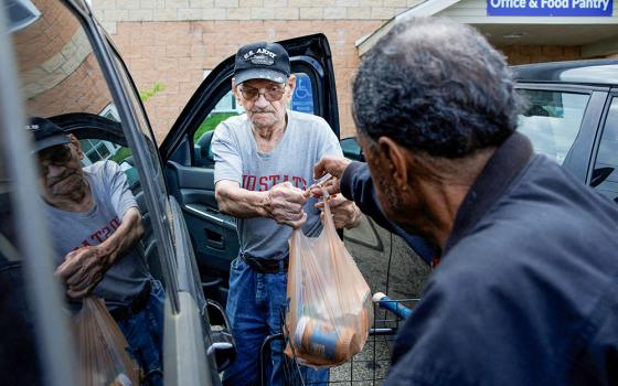 Volunteer Walter Rogers, 83, helps Merrill Hancock, 87, load the groceries he received May 12, 2025, from the Eastside Community Ministry pantry in Zanesville, Ohio. (OSV News/Reuters/Evelyn Hockstein)