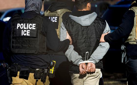 Agents with the Immigration and Customs Enforcement detain a man after conducting a raid at the Cedar Run apartment complex in Denver Feb. 5, 2025. (OSV News/Reuters/Kevin Mohatt)