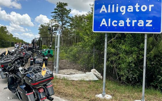 Motorcycles ridden by Miami Archbishop Thomas Wenski and Knights on Bikes are parked in front of the entrance to Alligator Alcatraz, a controversial immigration detention facility some 55 miles from Miami in the Florida Everglades. The archbishop and his fellow bikers stopped to pray a rosary for detainees July 20, 2025. (OSV News/Thomas G. Wenski)