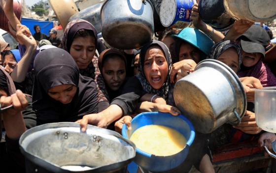 Palestinians gather to receive food from a charity kitchen in Gaza City July 24, 2025, amid a hunger crisis. For months, U.N. officials, aid groups and experts have warned that Palestinians in the Gaza Strip are on the brink of famine without formally declaring one. (OSV News/Dawoud Abu Alkas/Reuters)
