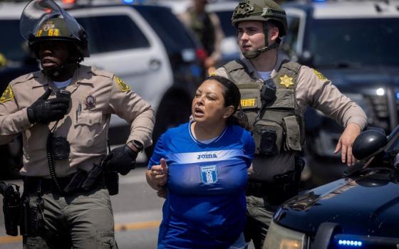 Los Angeles County Sheriff's deputies detain a woman during a standoff by protesters and law enforcement following multiple detentions by U.S. Immigration and Customs Enforcement in Compton, Calif., June 7, 2025. Los Angeles business leaders joined Archbishop José Gomez July 23 to unveil a new fund aimed at helping families affected by recent immigration raids. (OSV News/Reuters/Barbara Davidson)