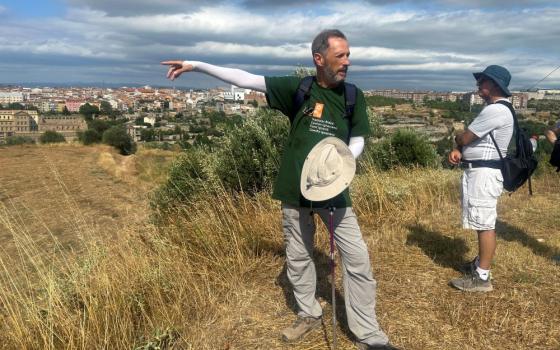 Jesuit Fr.  Josep Lluis Iriberri points toward Manresa, where his group of pilgrims will conclude the Ignatian Way pilgrimage, in Spain, July 9. (AP/Joseph Wilson)