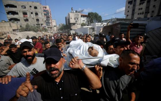 Mourners carry bodies of Palestinians in Gaza City, July 30, who were killed by Israeli fire while trying to receive aid. (OSV News/Reuters/Mahmoud Issa)