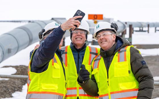 From left, Interior Secretary Doug Burgum, Energy Secretary Chris Wright and Environmental Protection Agency Administrator Lee Zeldin pose for a selfie with the Trans-Alaska oil pipeline in the background after a news conference at Pump Station 1 on June 2, 2025, near Deadhorse, Alaska. (AP/Jenny Kane)
