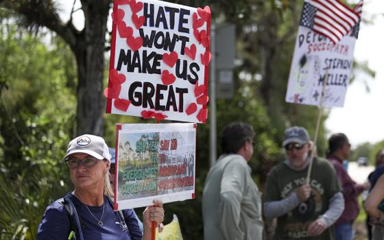 A protester stands outside the migrant detention facility dubbed "Alligator Alcatraz" at the Dade-Collier Training and Transition Facility, July 12, 2025, in Ochopee, Flordia. (AP photo/Alexandra Rodriguez)