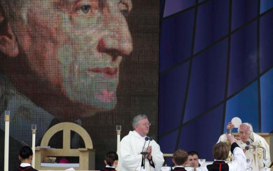 Pope Benedict XVI, right, celebrates a beatification mass for Cardinal John Henry Newman in Birmingham, England, Sunday, Sept. 19, 2010. (AP/Gregorio Borgia)