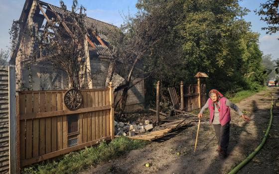  A woman walks past a destroyed home at the site of a Russian airstrike in the Ukrainian village of Sknyliv on the outskirts of Lviv, Aug. 21, 2025. (OSV News photo/Roman Baluk, Reuters)