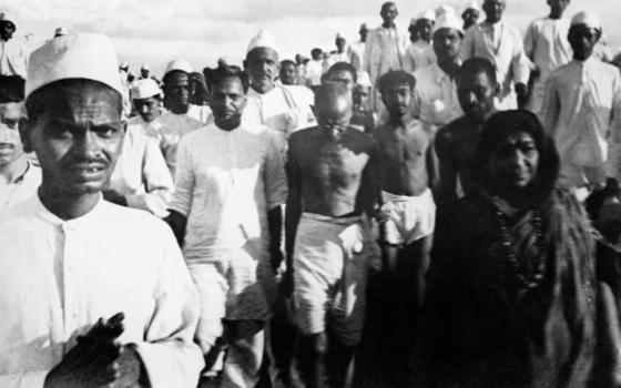 Mohandas Gandhi, center, walks during a peaceful protest called the salt march on March 12, 1930. (Wikimedia Commons)