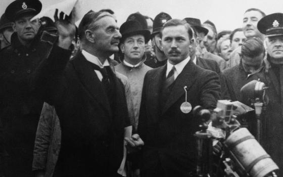 British Premier Neville Chamberlain waves what he called the "no war" pact at Heston Aerodrome in London Sept. 30, 1938.