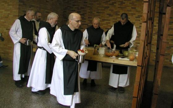 Trappist monks who live at the Abbey of Gethsemani prepare to eat lunch in their dining hall in late March 2011 in Trappist, Ky. Fifty 50 men lived in the community then; about 40 live there now. (CNS/Marnie McAllister, The Record)